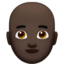 Man: Dark Skin Tone, Bald emoji on Apple