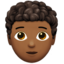 Person: Medium-Dark Skin Tone, Curly Hair emoji on Apple