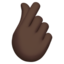 Hand with Index Finger and Thumb Crossed: Dark Skin Tone emoji on Apple